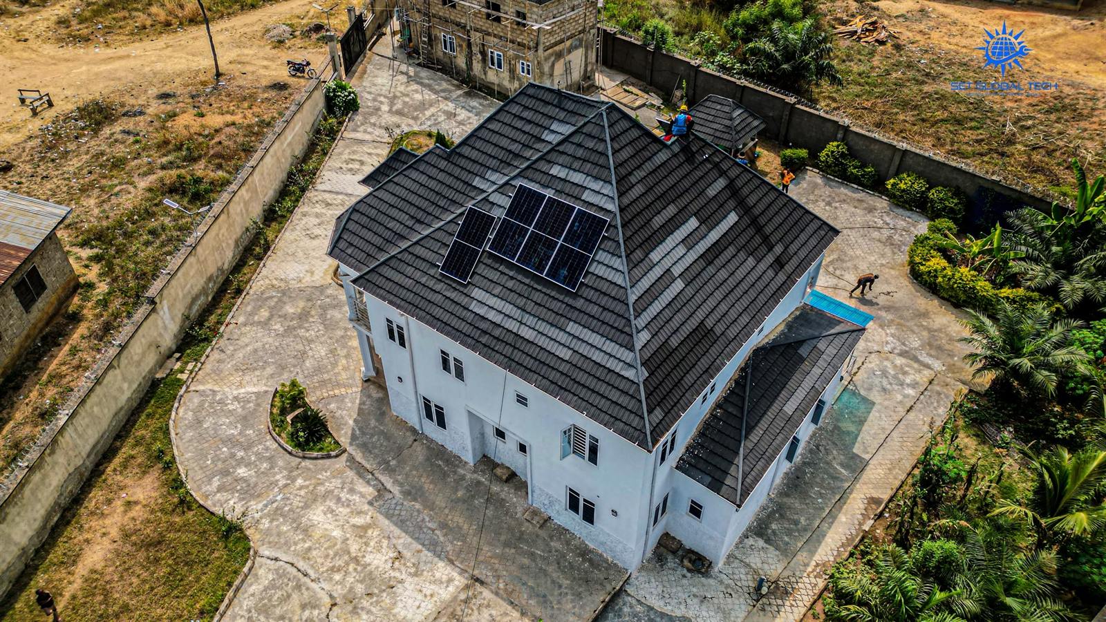Wide aerial view of a home with solar panels on the roof