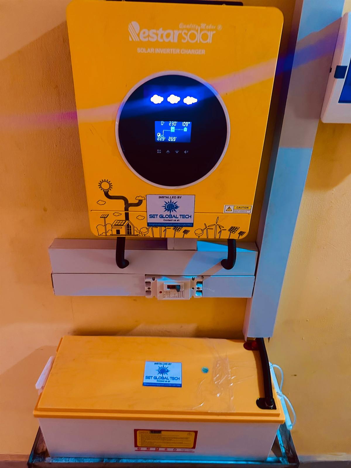 Yellow Nestar inverter mounted above a battery