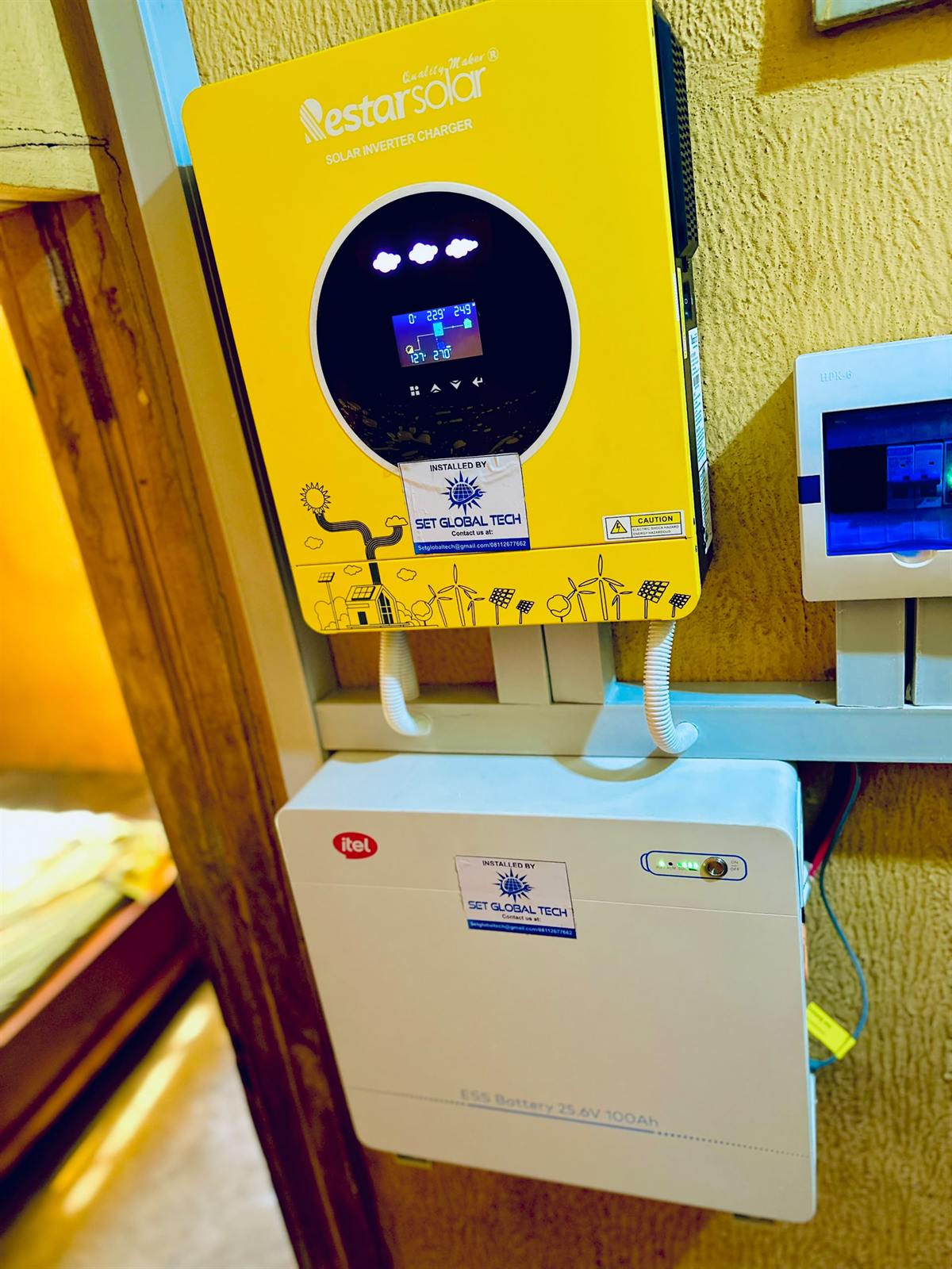 Yellow Nestar inverter above an Itel lithium battery, both labelled installed by SetGlobalTech