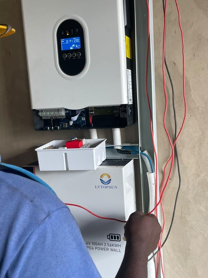 Close view of inverter terminals and a lithium battery during wiring