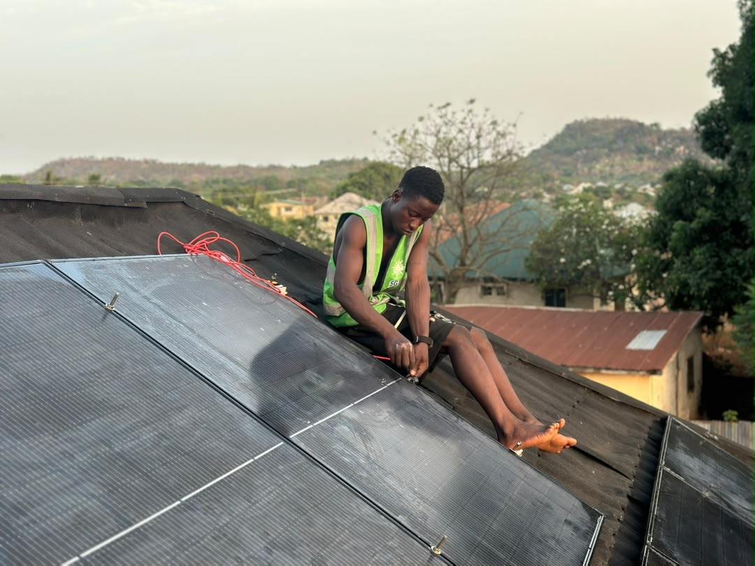 Installer connecting cables between solar panels